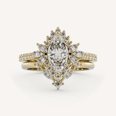 a yellow gold engagement ring with a pear shaped diamond surrounded by two smaller pears