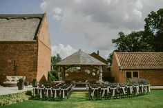 an outdoor wedding venue with chairs and tables set up for the guests to sit in