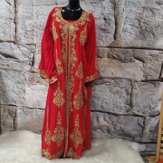 This Elegant 2 Pieces Red And Gold Embroidered Abaya Features Intricate Gold Ornate Embroidery Along The Neckline, Down The Front, And On The Edges Of The Sleeves And The Bottom Hem. The Set Includes One Dress And A Long Embroidered Kimono/Goddess Duster/Cover Up. Size: Large Bust:46" Hips:48" Length:58" Sleeves: 28" Red Embroidered Dress With Traditional Drape For Wedding, Red Floor-length Traditional Wear With Floral Embroidery, Red Dabka Maxi Length Dress, Red Embroidered Dress With Traditional Drape For Festivals, Festive Anarkali Kaftan With Long Sleeves, Red Ceremonial Kaftan For Festivals, Embroidered Red Floor-length Traditional Wear, Long Sleeve Red Abaya For Wedding, Red Dabka Abaya For Eid