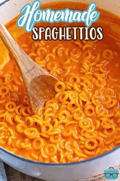 a wooden spoon in a large pot full of homemade spaghetti soup with the title above it