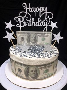 a birthday cake decorated with money and sparkles