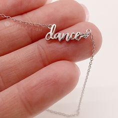 This dainty dance necklace is the perfect gift for any dance team, dance coach, dance mom, or dance recital! This tiny dance pendant is delicate and simple, perfect for stacking or layering with other jewelry. Made from quality solid .925 Sterling Silver that is tarnish-resistant and suitable for sensitive skin, with high quality Cubic Zirconia stones with the perfect amount of sparkle. The chain is adjustable so she'll find her perfect length. Designed and shipped from a small business in Arizo Dainty Adjustable Sterling Silver Name Necklace, Adjustable Sterling Silver Name Charm Necklaces, Adjustable Sterling Silver Name Charm Necklace, Silver Adjustable Jewelry For Dance, Dance Coach, Dance Necklace, Dance Jewelry, Dance Mom, Necklace Extender