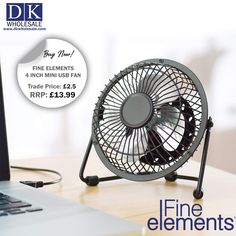 a desk fan sitting on top of a wooden table next to a laptop and mouse