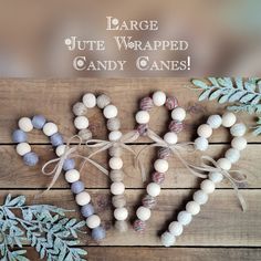 some white and blue candy canes are arranged in the shape of a heart on a wooden table