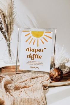 there is a sign that says diaper raffle next to some dried plants and a vase