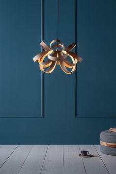 a chandelier hanging from the ceiling in a room with blue walls and wood flooring