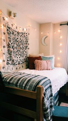 a bedroom with string lights on the wall and a bed in front of a window