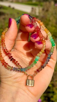 This 19" necklace is made with a rainbow of gemstones including Heliodor, Citrine, Prehnite, Chrysoprase, Garnet,  Kyanite, Iolite, Red Sunstone, Aquamarine, and Topaz. The gems are a mix of smooth and faceted and range in width from 5mm - 5.5mm. Each bead is knotted in place on silk cord that's been hand dyed in a vibrant shade of lime green. Finished with 14/20 gold filled signature cord ends and open loops paired with a 14k gold vermeil interchangeable padlock clasp. Rainbow Rondelle Necklace For Gift, Rainbow Rondelle Necklace Gift, Padlock Necklace, Rainbow Gemstones, Rainbow Crafts, Rainbow Jewelry, Rainbow Necklace, Cord Ends, Silk Cord