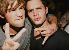 two young men making the peace sign with their fingers