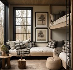 a bedroom with bunk beds, pillows and pictures on the wall next to each other