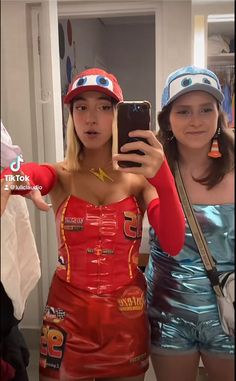 two women in costumes are taking a selfie