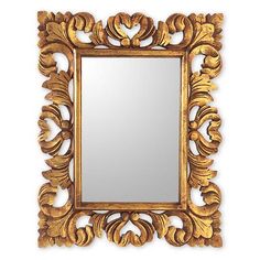 a gold framed mirror with an ornate design on the front and sides, against a white background