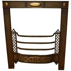 an antique iron fireplace screen with decorative carvings