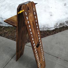 a wooden bench sitting on top of snow covered ground