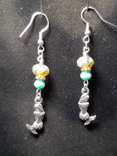 double sided  silver mermaid charm earrings.  Earring height: 1.5 in Earring Width: .5 in Silver Mermaid, Mermaid Earrings, Small Business Ideas, Charm Earrings, Business Ideas, Jewelry Earrings Dangle, Labour Day, Etsy Earrings, Double Sided