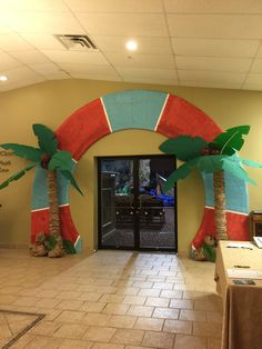 an entrance to a building decorated with palm trees