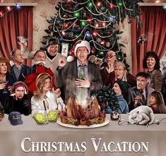 a large group of people standing around a table with a christmas vacation poster on it