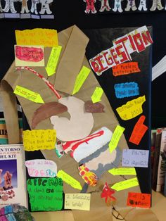 a paper bag with writing on it sitting next to some books and other items in front of them