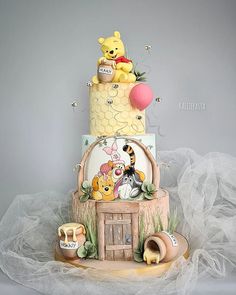 a winnie the pooh birthday cake is on display