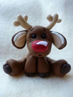 a small brown toy sitting on top of a white sheet