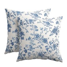 two blue and white pillows with flowers on them