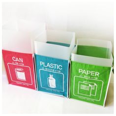 four different types of paper bags on a white surface with the words plastic in red, green and blue