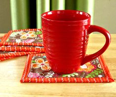 two red cups sitting on top of coasters