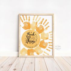 a yellow and white print with the words thank you for sunshine on it in front of a wooden frame