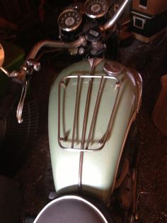 an old motorcycle is sitting on the ground with it's front wheel still attached