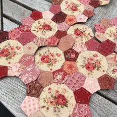 several hexagons with flowers on them sitting on a bench