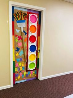 there is a door decorated with paint and brushes