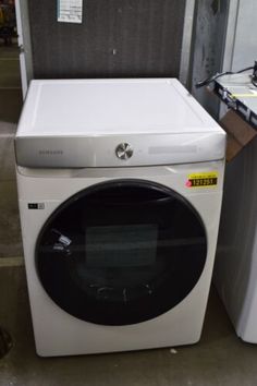 a white washing machine sitting next to a dryer