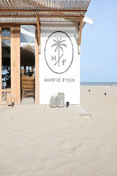 a white building with a sign that says hippie fish on it's side