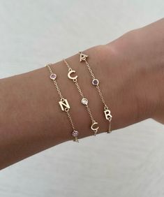 This beautiful bracelet features up to six 14K gold letters of your choice. Choose from several options for the accent stones! EXAMPLE SHOWN: Letter #1: R Stone #1: diamond Letter #2: J Stone #2: diamond Letter #3: J Available in 14K Yellow Gold, 14K White Gold or 14K Rose Gold Measures 6" + 1" extender Letter measures approx. 5mm Each letters measurement will vary slightly based on the letter FINAL SALE 14k Gold Bracelet With Initials For Anniversary, Elegant Personalized Diamond Bracelets, Luxury 14k Gold Name Bracelet With Initials, Classic Personalized Diamond Bracelets, Personalized Classic Diamond Bracelets, Personalized 14k Yellow Gold Diamond Bracelet, Personalized Diamond Bracelet For Anniversary, Personalized Cubic Zirconia Bracelets, Personalized Round Cubic Zirconia Bracelets