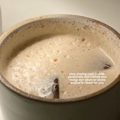 a cup filled with liquid sitting on top of a table