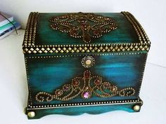 an ornately decorated box sitting on top of a table