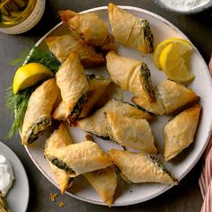 a white plate topped with pastries and lemon wedges