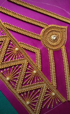 gold thread work on purple fabric