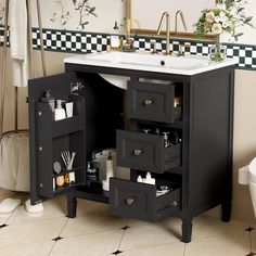 a bathroom with a sink, mirror and black cabinet in front of the toilette