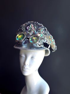 The hat is encrusted with iridescent crystals and sequins that catch the light and reflect a spectrum of colors, ensuring you stand out in any crowd. The silver spike goggles provide a striking contrast to the shimmering crystals, creating a perfect blend of elegance and rebellion. Age Group/Gender - Adult/Women Size/Type - One size fits all adults Color - Silver Special Features - Silver spike goggles Festival Hats, Festival Mode, Pop Custom, Military Hats, Rainbow Warrior, Burning Man Fashion, Festival Gear, Festival Hat, Burning Man Festival