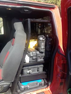 the inside of a red truck with its cargo compartment open