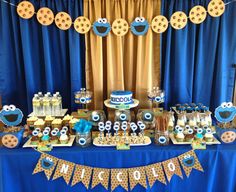 a dessert table with cookies and cupcakes on it