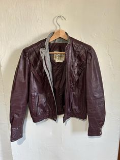 Very cool 1970's leather jacket by Berman's Leather Experts. Origin: Korea 100% Leather Shell 100% Nylon lining Era: 1970's Size: tag size reads 8 but this fits size small MEASUREMENTS Shoulders - 15" Sleeve- 22 1/2" Length, shoulder to hem: 20" Possibly never worn or only worn a couple of times. There is a small nick in the on the right shoulder on the front side. It could probably be filled in with a leather or fabric dye. See photos. Otherwise is perfect condition. I believe in fashion that is timeless not fast. Vintage clothing has a level of quality that today's clothes do not embody. Not only can it be timeless but can be reused for years to come. It's not only time to buy better quality but it is time to reduce, reuse and recycle. Let's love the world together. 🖤 #vintage #Bermans Y2k Leather Jacket, Purple Y2k, Purple Leather Jacket, Fabric Dye, Purple Leather, Todays Outfit, How To Dye Fabric, Dark Purple, Size Tag