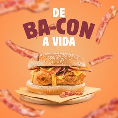 a bacon sandwich on a wooden board with bacon flying in the air behind it and an orange background that says de ba - con a vida