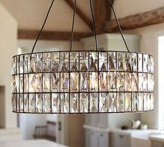 a chandelier hanging from the ceiling in a kitchen