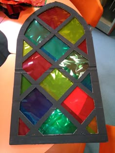 a stained glass window sitting on top of a table