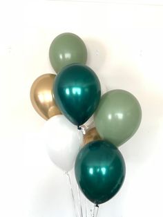 a bunch of balloons that are green and white in the shape of heart shaped balloons