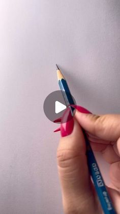 someone is holding a pencil in their left hand and pointing it at the viewer's thumb