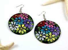 "Hand painted coconut shell circle disc earring 🔥🔥FREE SHIPPING🔥🔥  via USPS first class United States including Hawaii and Alaska These beautiful hand painted colorful flowers earrings are made from real coconut shell. They are perfect for a gift or any occasion to bring a smile to someone's face!     - lightweight and comfortable     - hand painted with acrylic paint     - stainless steel hooks     - eco friendly     - vegan friendly     - round 2.5\" for the large part of the shell, but 3.25\" hanging **Please note** Since they are hand painted, each pair looks slightly different.  CARE In order to keep them looking new, try to keep away from water due to the nature of the these earrings PACKAGE The item will come with a free drawstring jewelry pouch. It is perfect for a gift so a ha Multicolor Hand Painted Earrings For Beach, Multicolor Hand Painted Flower Earrings For Gifts, Multicolor Hand Painted Flower Earrings As Gift, Multicolor Round Flower Earrings, Colorful Round Earrings For Beach, Handmade Summer Flower Earrings, Recycled Gifts, Free Boxes, Hand Painted Earrings