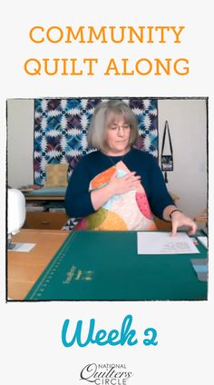 a woman sitting at a table with a piece of paper in front of her and the words community quilt along on it